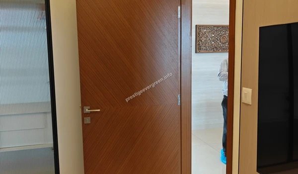 Internal wooden door featuring a diagonal grain pattern within the 1486 sqft Prestige Evergreen apartment