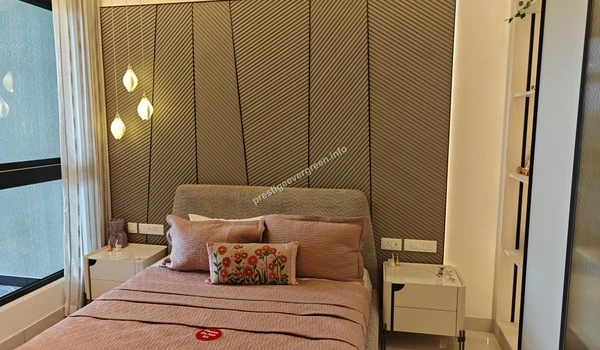 Master bedroom interior at Prestige Evergreen 1486 sqft model home featuring designer headboard and warm ambient lighting