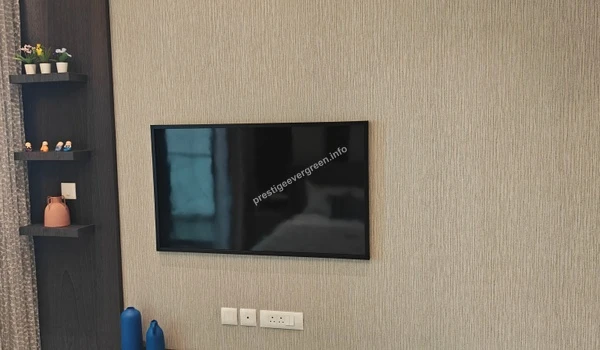 Wall-mounted television setup in the Prestige Evergreen 1486 sqft residence featuring a textured wallpaper backdrop