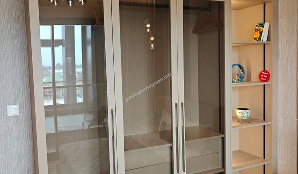 Premium walk-in closet design at Prestige Evergreen 1486 sqft unit featuring glass-fronted wardrobes and integrated storage