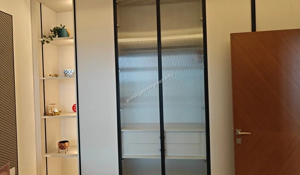 Customized wardrobe design with fluted glass doors in the 1486 sqft Prestige Evergreen model apartment