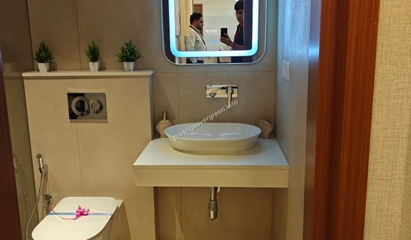 Modern bathroom vanity at Prestige Evergreen 1486 sqft unit featuring a backlit mirror and premium ceramic wash basin