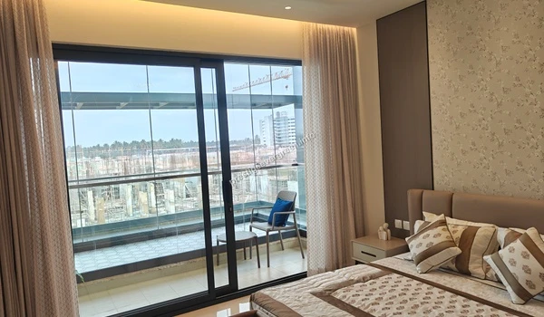 Wide view of the master bedroom and attached balcony at Prestige Evergreen showing the seamless transition between the indoor living space and the outdoor deck