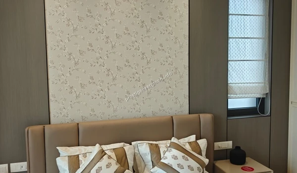 Luxury 3 BHK master bedroom at Prestige Evergreen featuring a premium floral wallpaper accent wall, cushioned headboard, and elegant window blinds