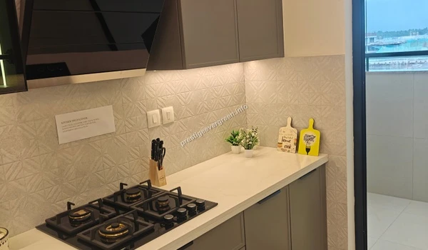 Modern modular kitchen interior of a 3 BHK apartment at Prestige Evergreen featuring elegant grey cabinetry and high-end built-in appliances