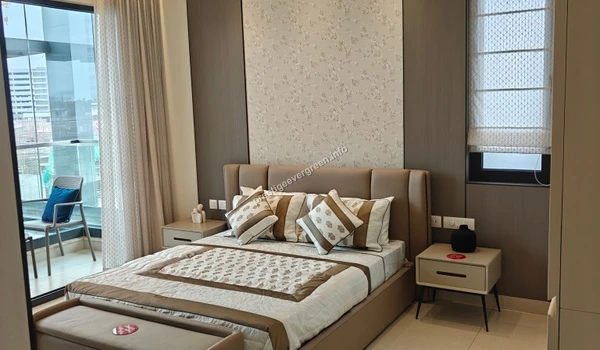 Spacious master bedroom in a 3 BHK apartment at Prestige Evergreen featuring an elegant headboard, designer wallpaper, and a large window leading to a private balcony