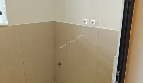 Dedicated service corner in the utility balcony of a Prestige Evergreen apartment showing electrical sockets and water inlet points for a washing machine