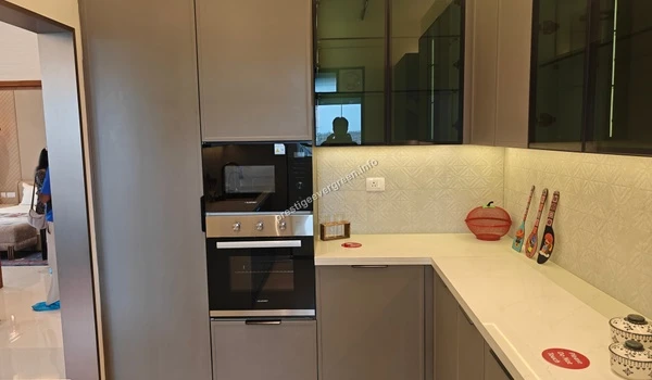 A view of the built-in microwave and oven unit within the Prestige Evergreen modular kitchen highlighting the sleek integrated design