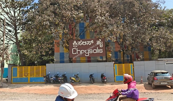View of the Chrysalis High School signage and parking area located near Prestige Evergreen