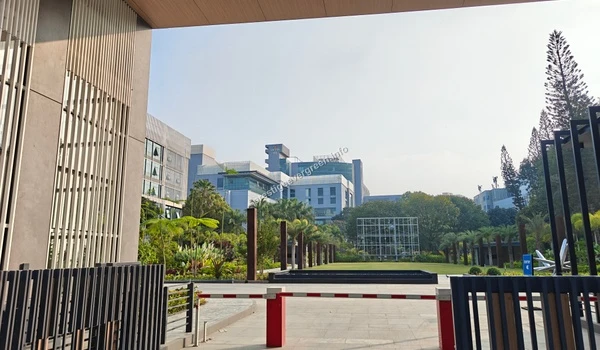 An expansive view of the landscaped greenery and modern office buildings within a tech park campus located in the Prestige Evergreen vicinity