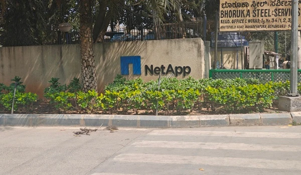 Perspective view of a premium glass-walled corporate office building providing employment hubs for Prestige Evergreen residents