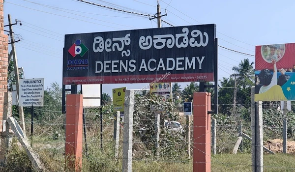 The prominent roadside signage for Deens Academy Gunjur highlighting the school's location and accessibility for Prestige Evergreen families