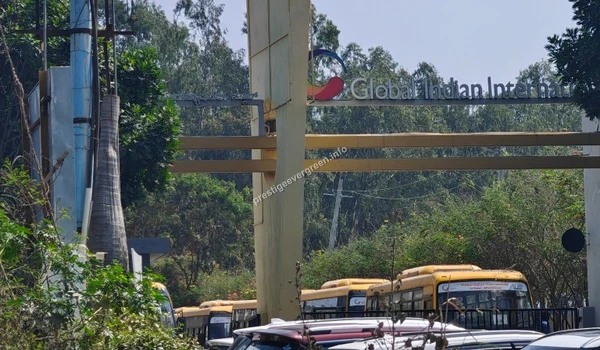 The prominent entrance archway of Global Indian International School featuring the school name and logo near the Prestige Evergreen development