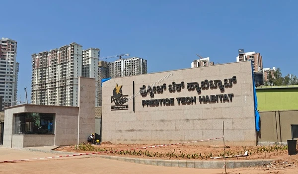 The main entrance plaza of Prestige Tech Habitat featuring landscaped areas and modern office architecture