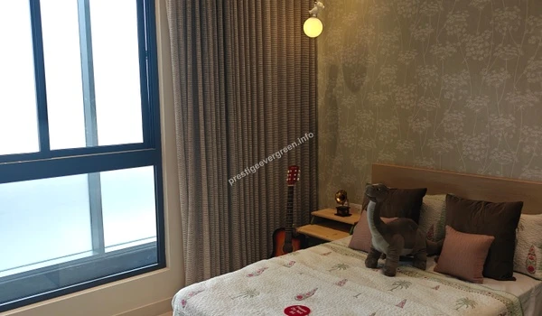 Charming kids bedroom at Prestige Evergreen featuring dinosaur-themed decor, botanical wallpaper, and soft warm lighting