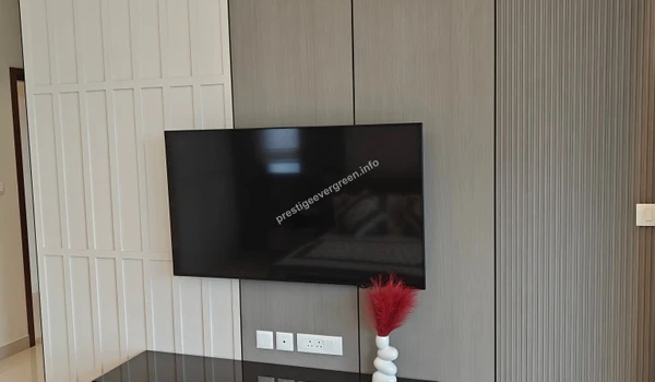 Modern wall-mounted TV unit at Prestige Evergreen with sleek grey and white paneling and minimalist decorative accents