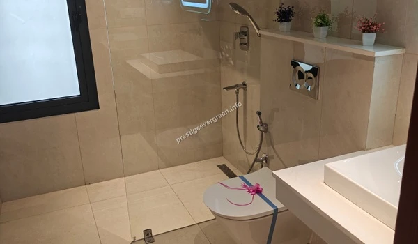 Contemporary bathroom at Prestige Evergreen featuring premium beige tiling, a walk-in shower area, and elegant fixtures