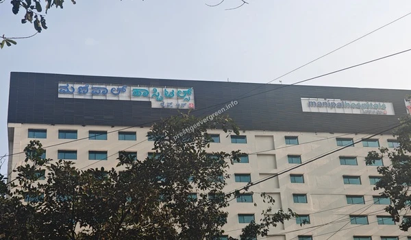 Exterior view of the Manipal Hospitals building facade and signage area surrounded by greenery at Prestige Evergreen