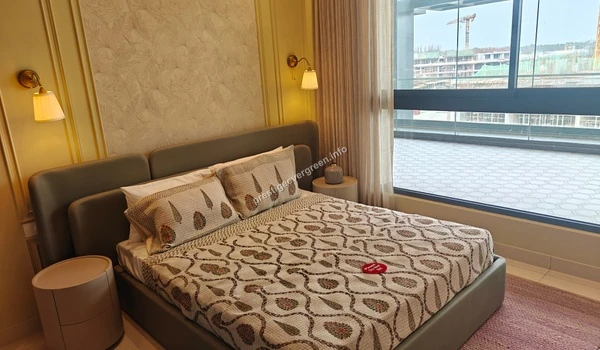 Spacious master bedroom at Prestige Evergreen with premium bedding, designer wallpaper, and large windows providing natural light