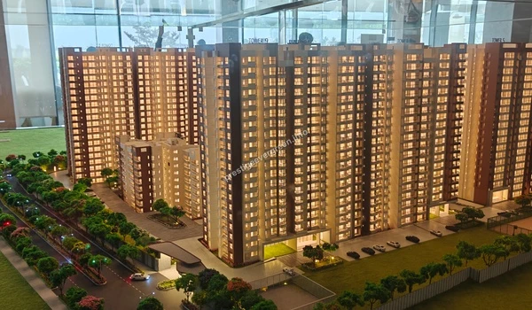 Close-up architectural detail of the Prestige Evergreen model featuring the expansive open green spaces and park areas surrounding the residential towers