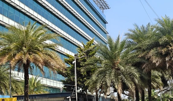 Close-up view of the modern glass facade of the NetApp IT Park building near Prestige Evergreen