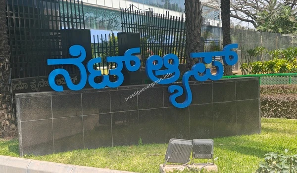 Close-up view of the NetApp corporate signage in English and Kannada near Prestige Evergreen