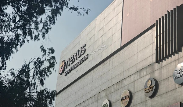 Close-up of the Nexus Shantiniketan logo and restaurant signage, adding to the excellent culinary and social infrastructure near Prestige Evergreen.