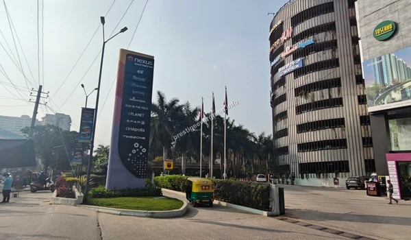 The iconic circular parking tower at Nexus Shantiniketan, indicating the vast amenities and conveniences accessible to Prestige Evergreen residents.