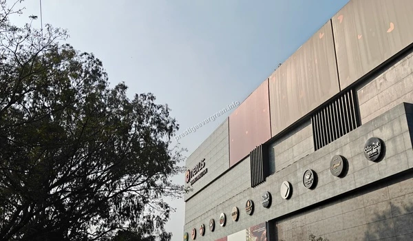 A view of the upper facade and branding at Nexus Shantiniketan, reflecting the upscale commercial development surrounding Prestige Evergreen.