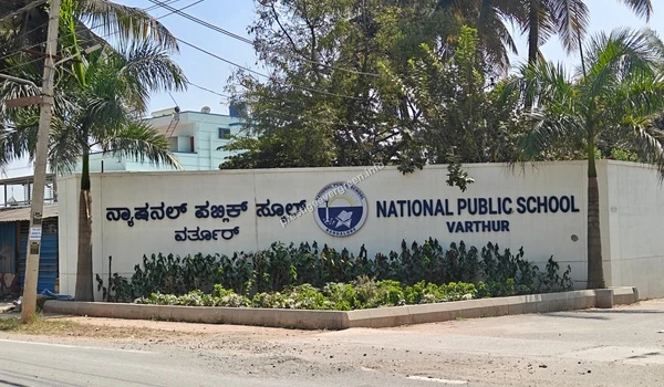 The prominent boundary wall and signage of National Public School NPS Varthur showcasing the premium educational facilities available for Prestige Evergreen residents