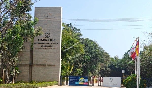 An angled perspective view of the Oakridge International School entrance signage and surrounding landscape near Prestige Evergreen