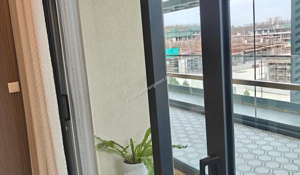 View of the expansive private deck at Prestige Evergreen with stylish tiled flooring and large sliding glass doors leading into the living space