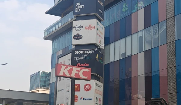 A towering sign displaying popular dining and retail brands like KFC and Hard Rock Cafe at Park Square Mall, easily accessible from Prestige Evergreen.