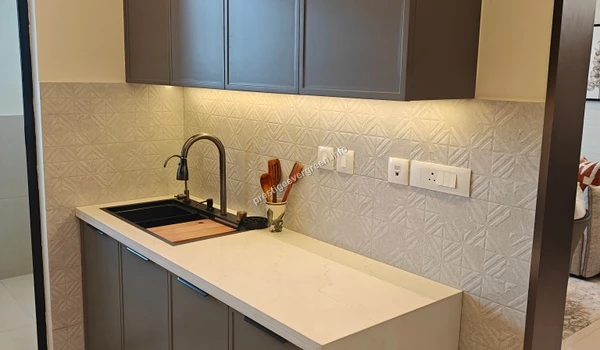 The integrated kitchen appliance unit at Prestige Evergreen showcasing a built-in microwave and oven within sleek modular cabinetry