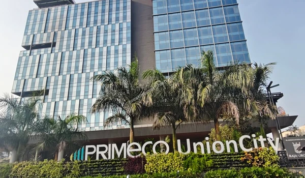Modern glass facade of the Primeco Union City building located near Prestige Evergreen