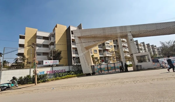 Angled view of The Prodigies International School entrance and campus building near Prestige Evergreen