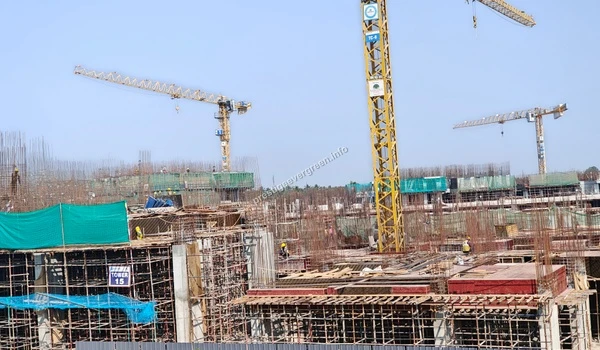 Close-up of the ongoing structural work at Prestige Evergreen highlighting the heavy machinery and tower cranes active at the Raintree Park site