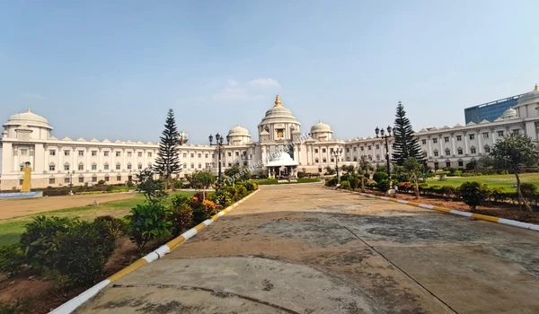 Perspective view of the paved driveway leading towards the grand white domed architecture of the medical institute near Prestige Evergreen