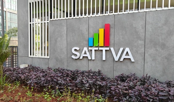The sleek Sattva corporate branding on a textured grey wall, representing the high-quality commercial neighbors of Prestige Evergreen