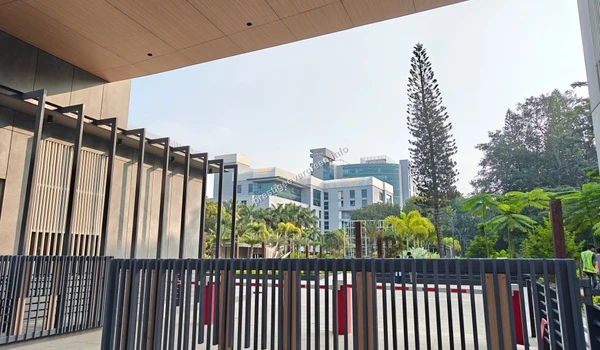 Modern architectural view of a tech park entrance and campus buildings, showcasing the professional landscape near Prestige Evergreen