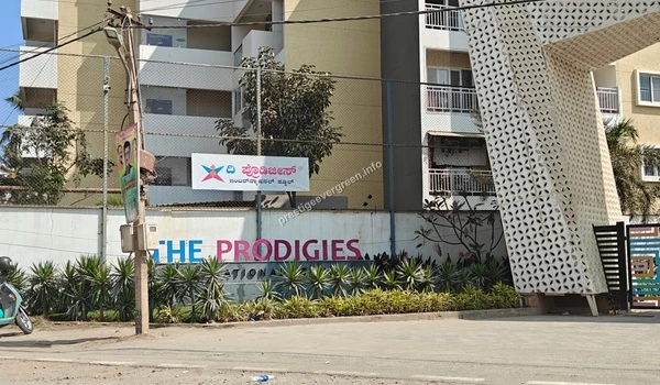 Entrance signage and boundary wall of The Prodigies International School near Prestige Evergreen