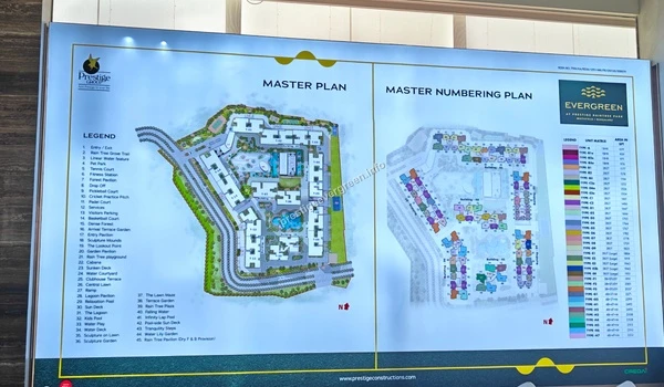 Active construction zone at Prestige Evergreen featuring structural tower progress and heavy-duty machinery under professional supervision