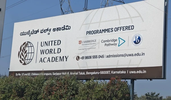 The official United World Academy (UWA) information billboard showcasing Cambridge and IB programs near Prestige Evergreen
