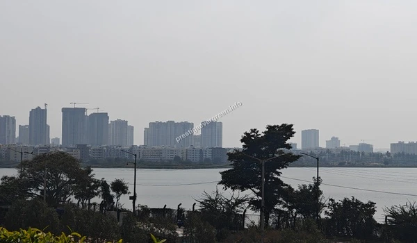 A breathtaking scenic panorama of Varthur Lake capturing the blend of natural beauty and urban infrastructure near the Prestige Evergreen community