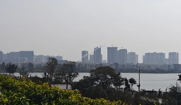 A serene waterfront vista of Varthur Lake from a prime vantage point at Prestige Evergreen highlighting the beauty of the local environment