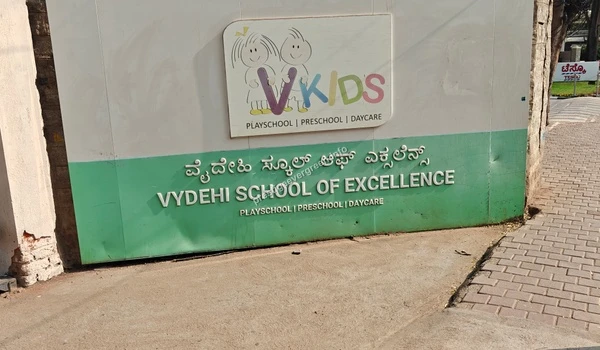The entrance signage of Vydehi School of Excellence and VKids Playschool located near Prestige Evergreen