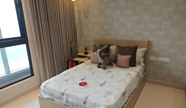 Youthful bedroom at Prestige Evergreen featuring dinosaur plush toys on a comfortable bed with leaf-patterned wallpaper accents