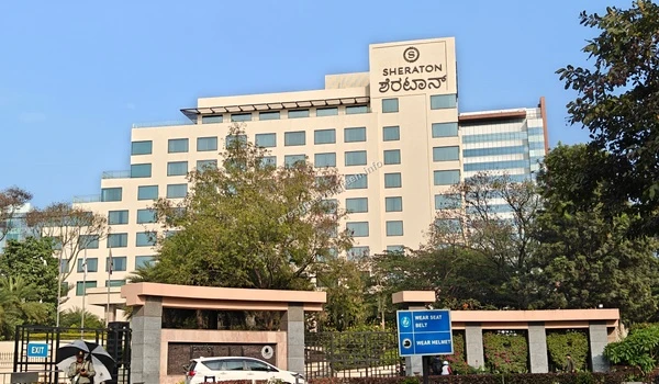 Full exterior view of the Sheraton Grand hotel building with main entrance gate near Prestige Evergreen