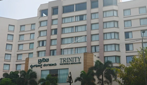 Exterior view of the Trinity Whitefield Bengaluru commercial building featuring glass windows near Prestige Evergreen